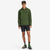 General shot of model wearing Topo Designs Men's Tech Breaker Jacket 4-way stretch windbreaker in olive green.