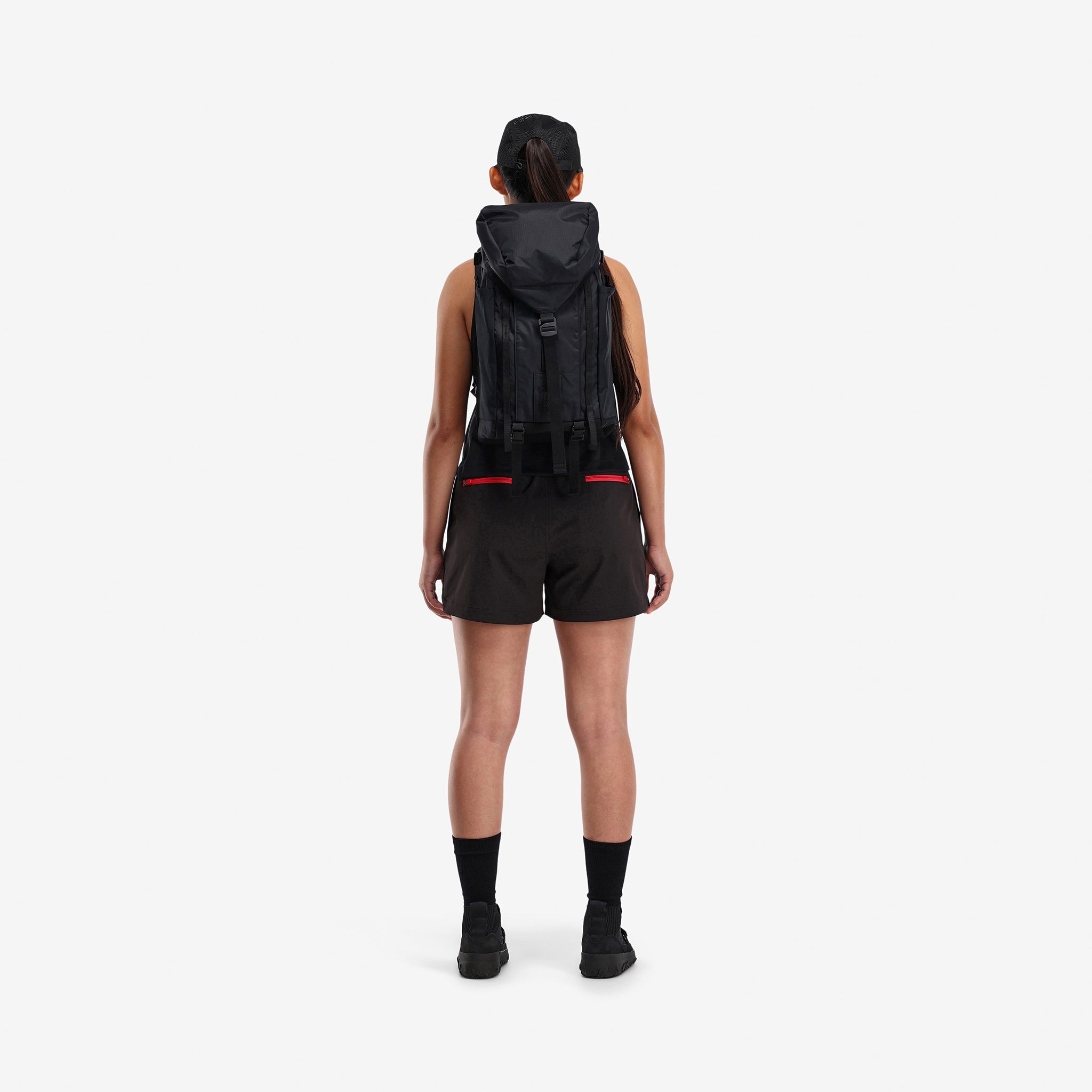 Back model shot of Topo Designs Women's Global lightweight quick dry travel Shorts in "Black"