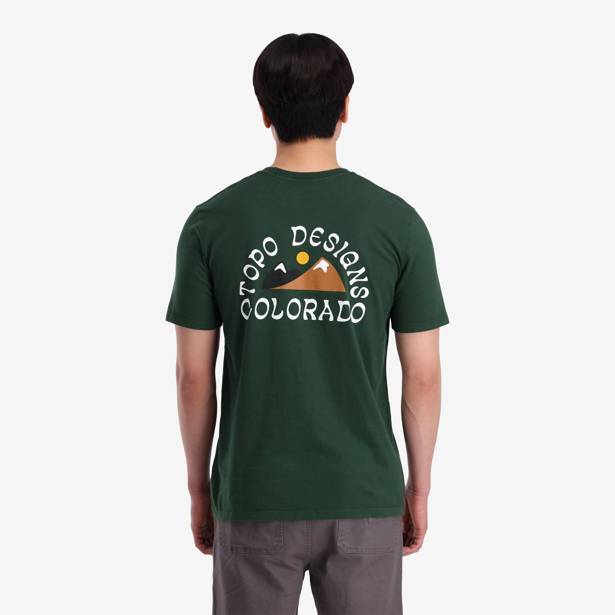 General shot back view of Topo Designs Men's Alpenglow Tee 100% organic cotton graphic short sleeve t-shirt in "forest" green.