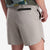 General on model side shot showing the zip back pocket feature of the Topo Designs Men's River Shorts Lightweight quick dry swim trunks in "Light Gray" gray.