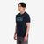 General shot on model left side view of Topo Designs Men's Small Diamond Tee 100% organic cotton short sleeve graphic logo t-shirt in "navy" blue.