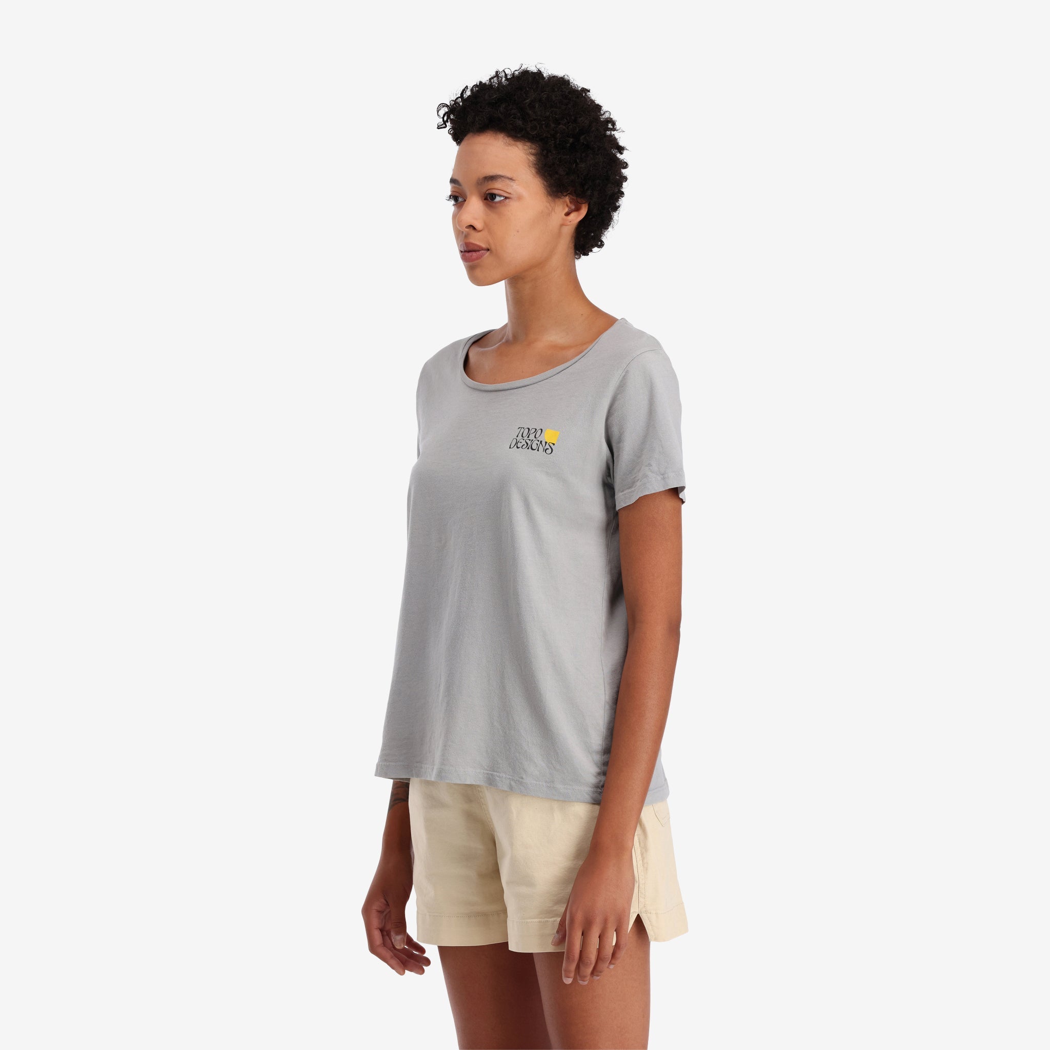 On model left side view of Topo Designs Women's Canyons Tee 100% organic cotton short sleeve graphic logo t-shirt in "gray".