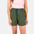 General close-up front model shot of Topo Designs Women's River Shorts in olive green.