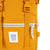 Detail shot of Topo Designs Rover Pack in Mustard yellow canvas showing logo patch and front zipper pocket.