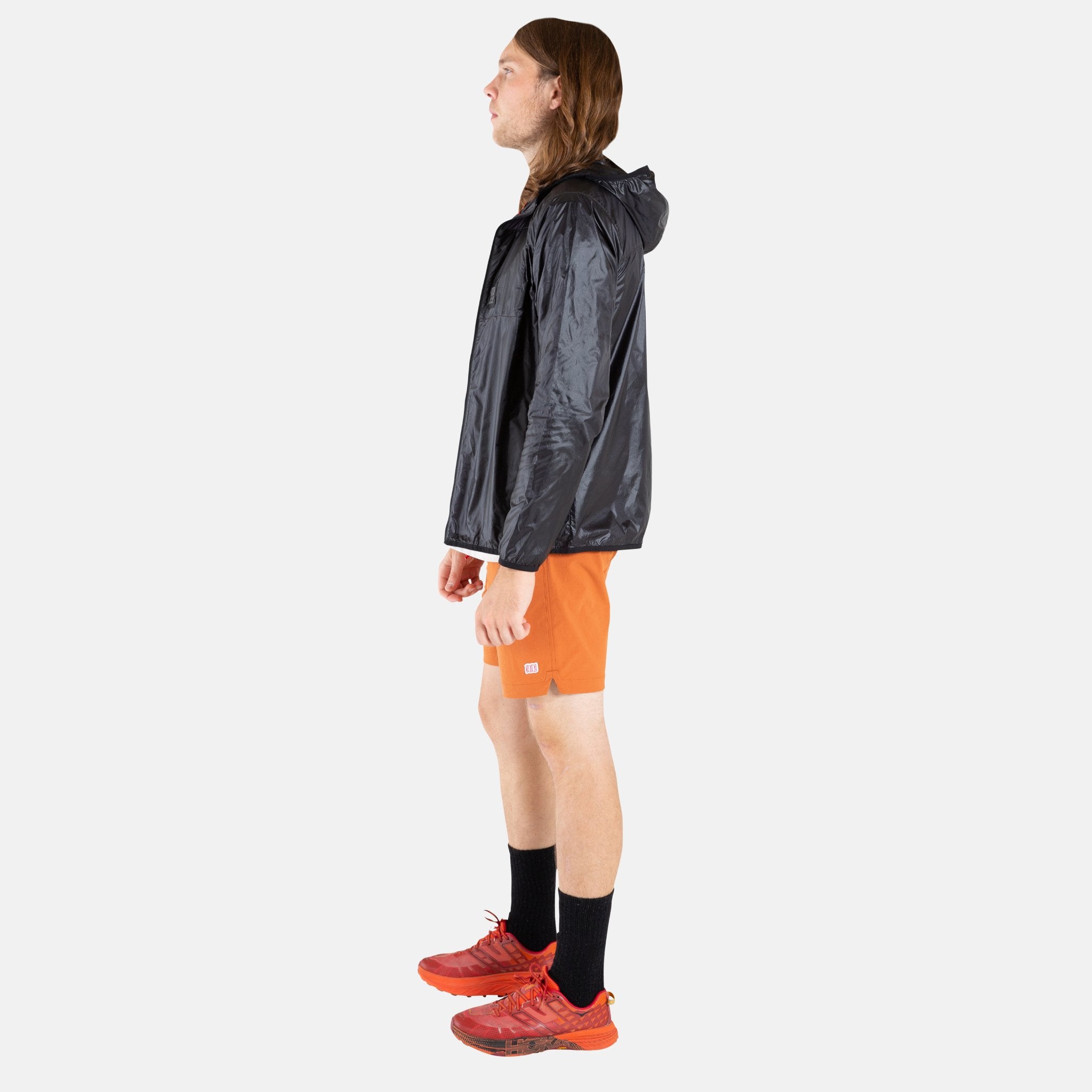 Side model shot of Topo Designs Men's Global Shorts in Clay.