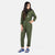 Front model shot of the Topo Designs Women's Coverall jumpsuit in Olive green showing hand pockets.