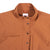 Detail shot of the Topo Designs Women's Coverall in Brick showing front snaps closed