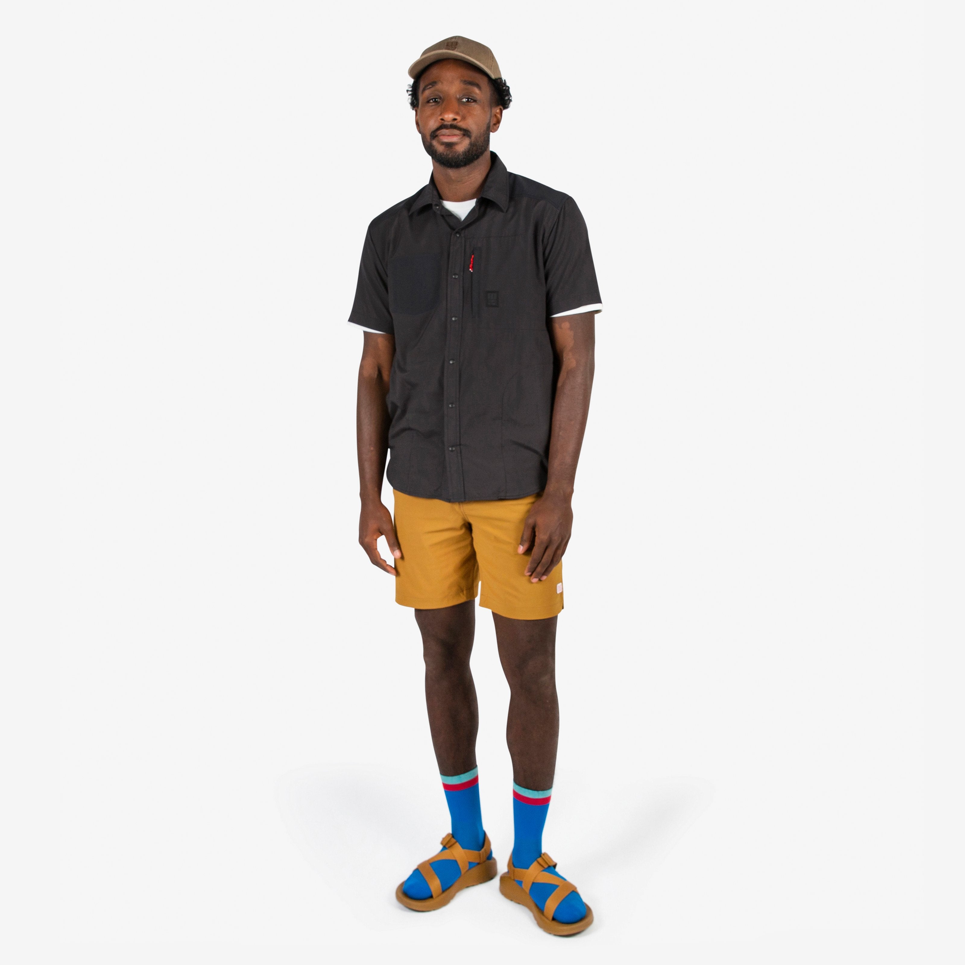 Topo Designs Men's Global lightweight quick dry travel Shorts in Dark Khaki brown on model.