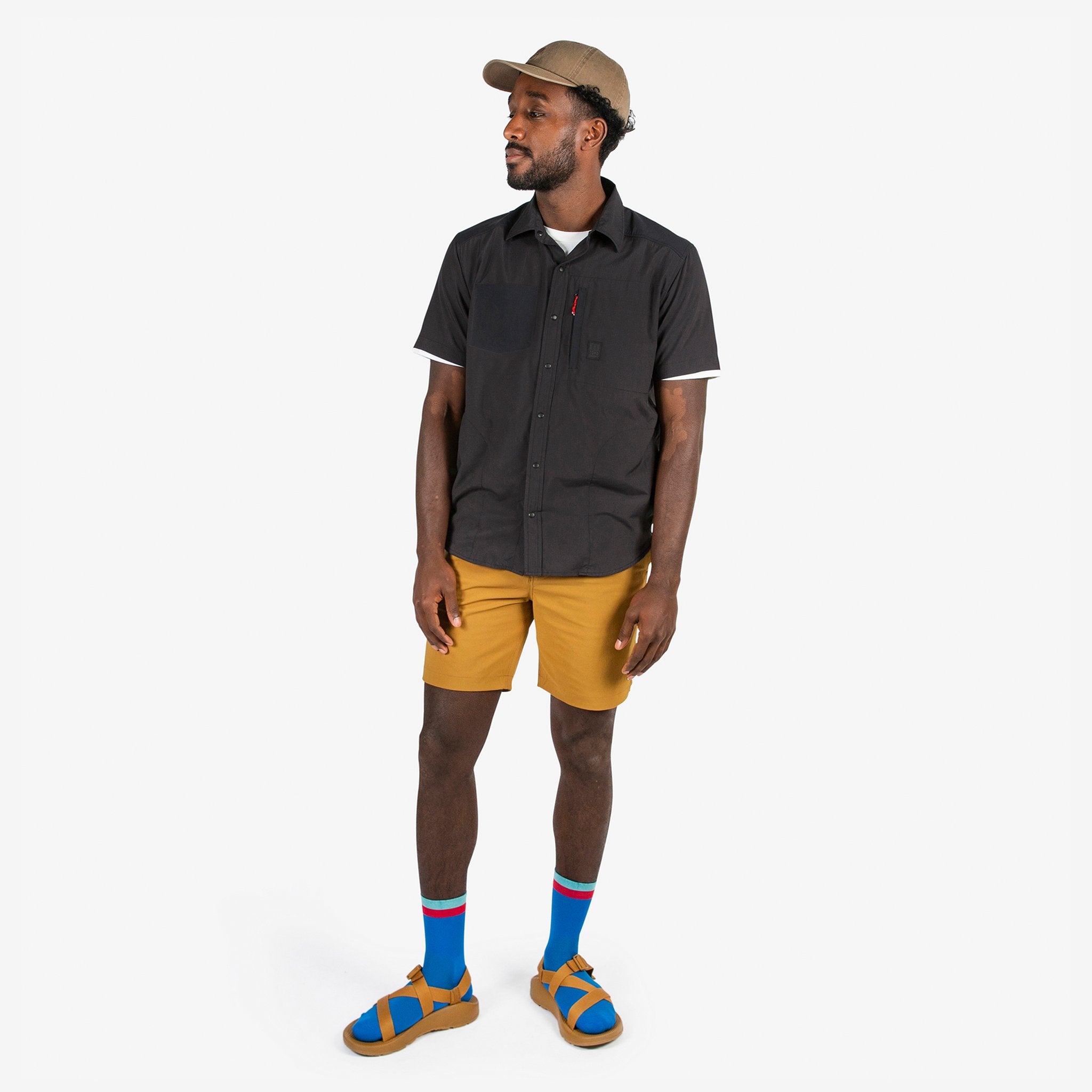 Topo Designs Men's Global lightweight quick dry travel Shorts in Dark Khaki brown on model.