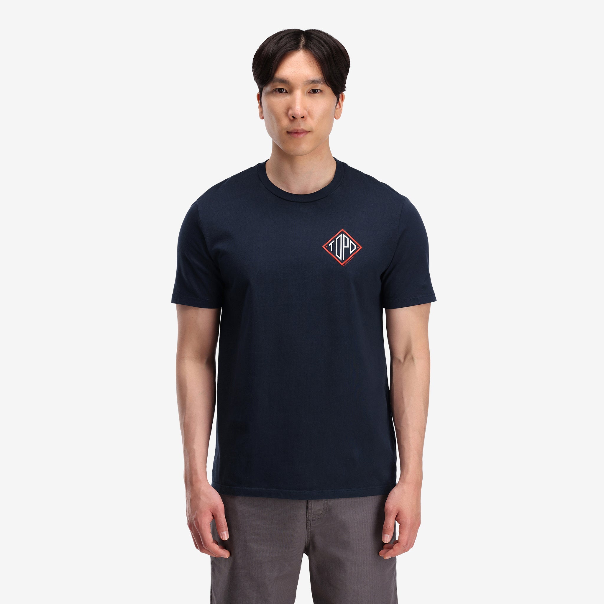 Gesamtaufnahme, auf Modell Vorderansicht von Topo Designs Herren Small Diamond Tee 100% Bio-Baumwolle Kurzarm-Grafik-Logo-T-Shirt in "navy" blau.