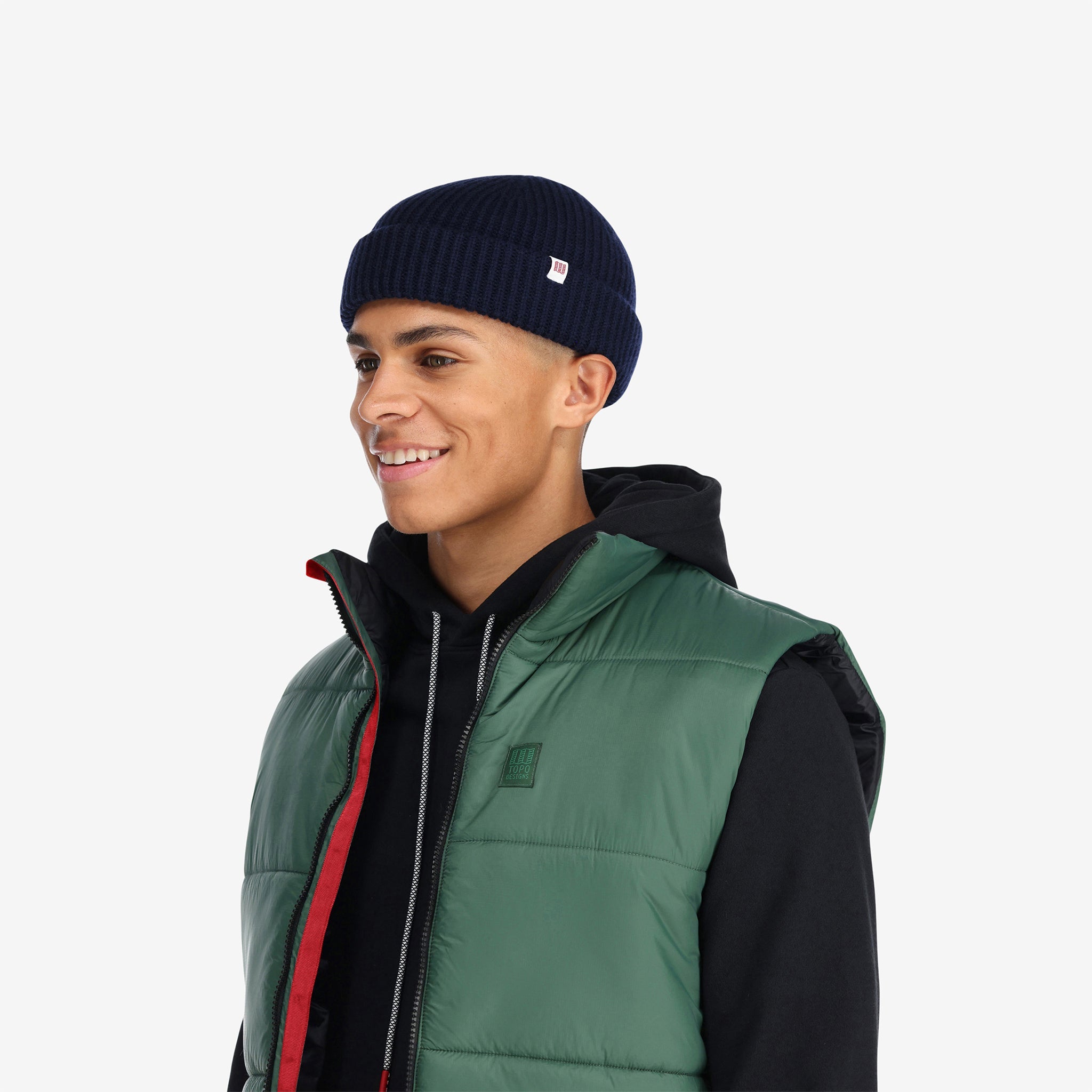 Vue de trois quarts du modèle de Topo Designs Hommes Mountain Puffer recycled insulated Vest en vert "Forest".